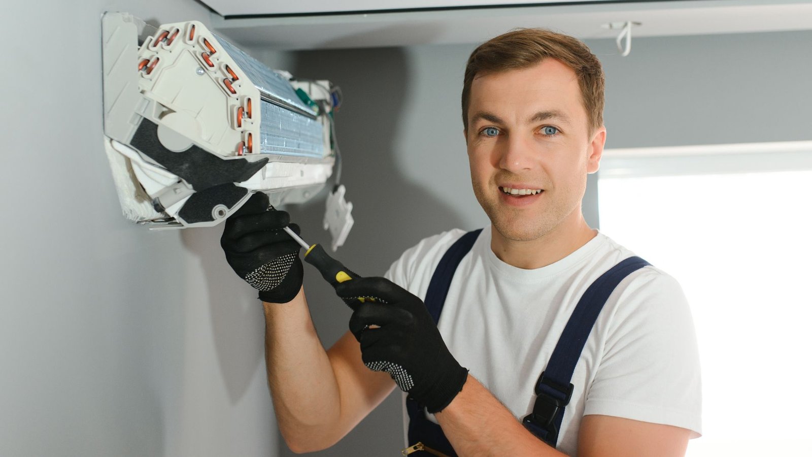 Indoor Climate Experts HVAC technician servicing AC unit in Lakeland, FL