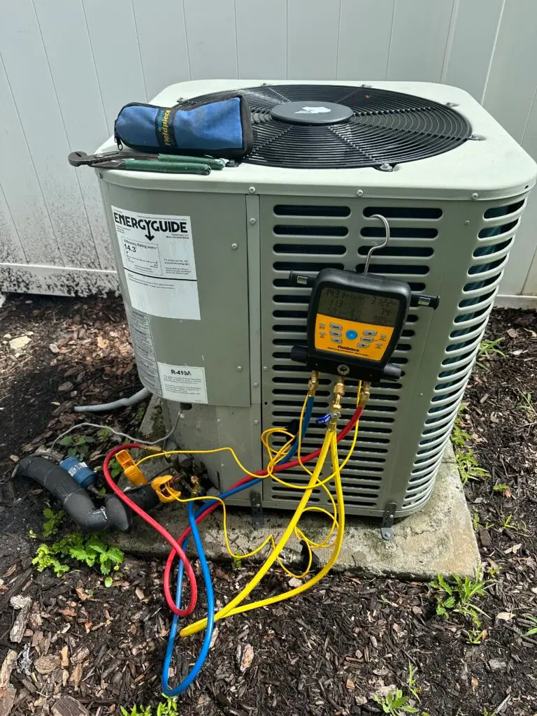 Indoor Climate Experts technician performing AC maintenance with gauges in Winter Haven, FL