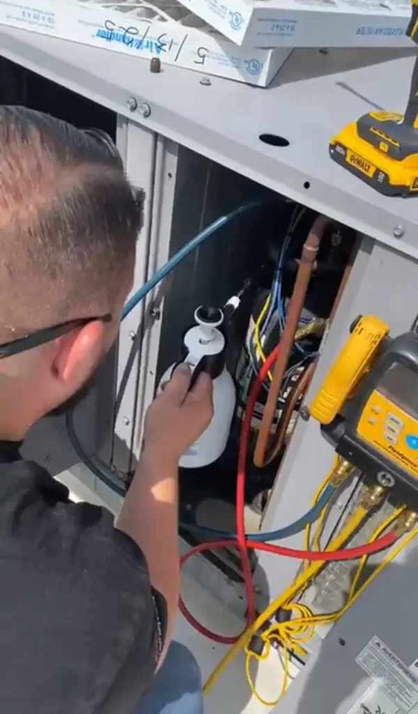 Indoor Climate Experts technician diagnosing an air conditioner's electrical components in Winter Haven, FL